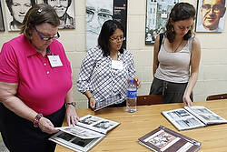 Members of a U.S. delegation interested in learning about the Salvadoran martyrs look at pictures in the Archbishop Romero Center at Central American University in San Salvador July 24. 