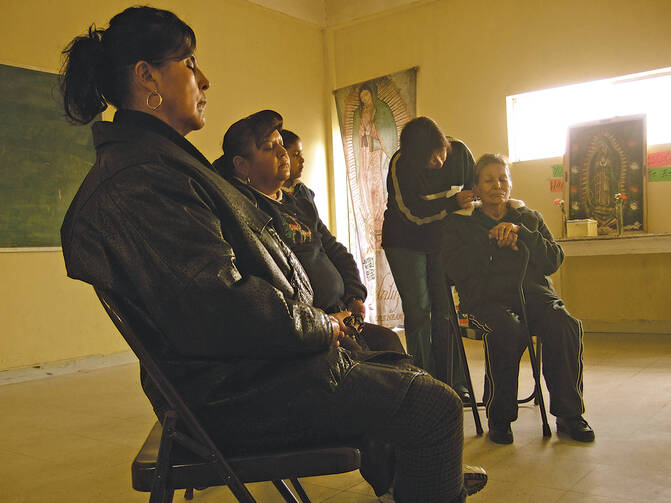 BE OPENED. Women rest in a church during ear acupuncture.