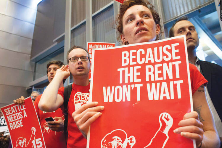 FIGHT FOR $15. Activists at a critical Seattle City Council meeting last Ju￼ne.