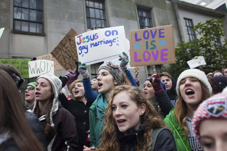 Eastside Catholic students rally in support of Mark Zmuda, the school’s former vice principal, outside the chancery building of the Archdiocese of Seattle on Dec. 20. (CNS photo/David Ryder, Reuters)