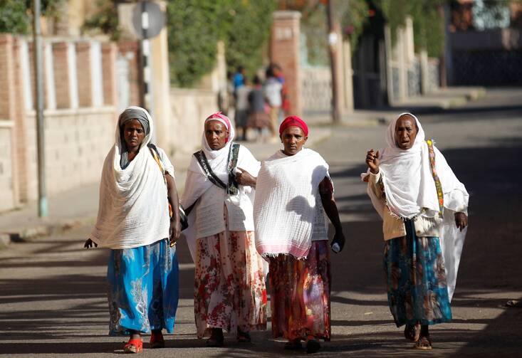 Women walk along a street Feb. 20, 2016, in Asmara, Eritrea. The nation's bishops said that because of years of war and unrest, "young people, mothers, children and families have become victims of exile and of destabilization." (CNS photo/Thomas Mukoya, Reuters)