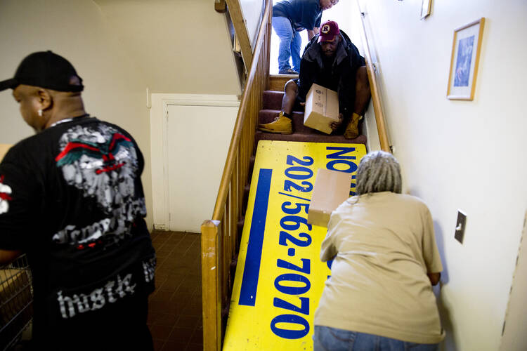 Volunteers with the Helping Hand Outreach Program at the Church of the Assumption of the Blessed Virgin Mary in Washington bring boxes of food to the church basement to stock the pantry shelves for impoverished members of the community in this 2013 photo.