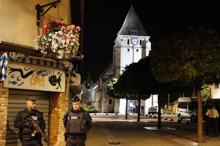 French riot police guards the street to access the church where an hostage taking left a priest dead in Saint-Etienne-du-Rouvray, Normandy, France on July 26. (AP Photo/Francois Mori)