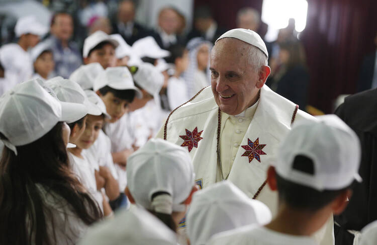 Pope Francis greets children from the refugee camps of Dehiyshe, Aida and Beit Jibrin at the Phoenix Center of the Dehiyshe Refugee Camp near Bethlehem, West Bank, on May 25.