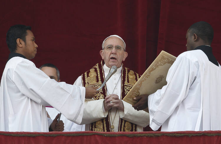 Pope Francis delivers his Christmas message and blessing "urbi et orbi" (to the city and the world) from the central balcony of St. Peter's Basilica at the Vatican Dec. 25. (CNS photo/Paul Haring)