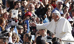 Pope Francis greets the crowd as he arrives to lead his general audience in St. Peter's Square at the Vatican Nov. 6. (CNS photo/Paul Haring) (Nov. 6, 2013) See POPE-AUDIENCE Nov. 6, 2013.