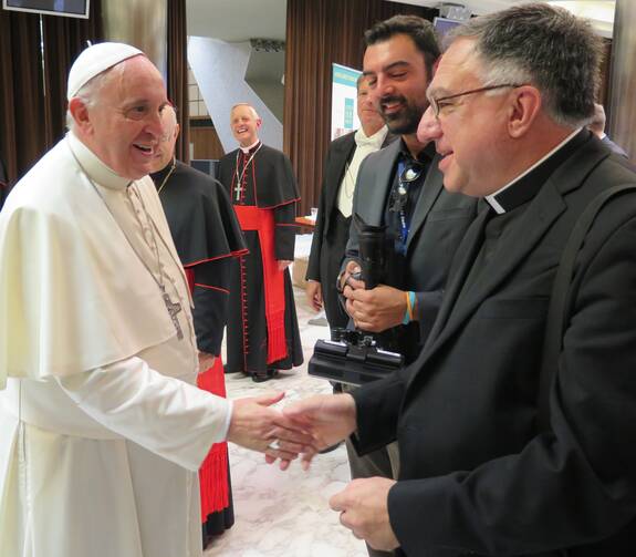 Pope Francis and Fr. Rosica, with Cardinal Donald Wuerl in the background.