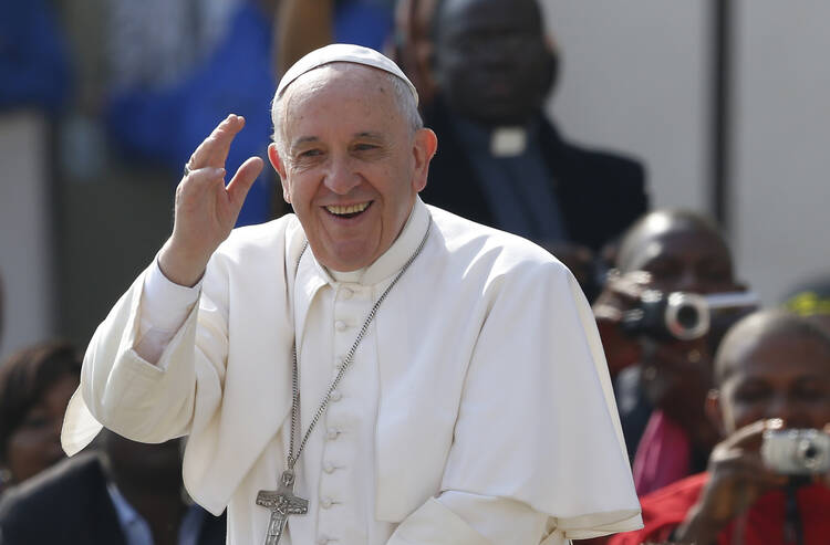 Pope Francis greets the crowd as he arrives to lead his general audience in St. Peter's Square at the Vatican on April 15. (CNS photo/Paul Haring) 