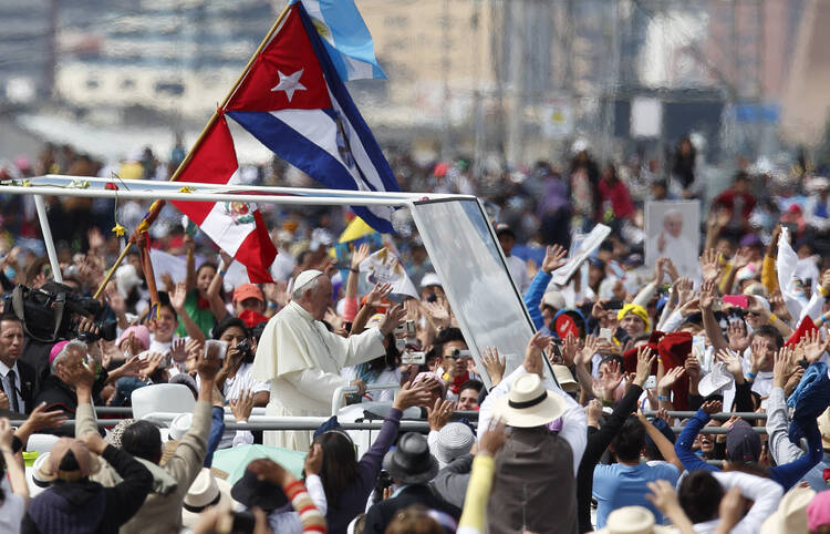 Pope Francis greets the crowd as he arrives to celebrate Mass in Bicentennial Park in Quito, Ecuador, July 7. (CNS photo/Paul Haring) 