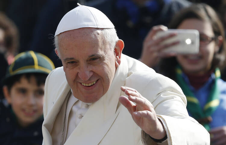 Pope Francis waves as he arrives to lead his general audience in St. Peter's Square at the Vatican March 11. (CNS photo/Paul Haring) 