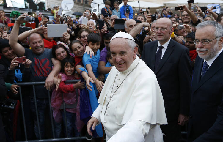 Pope Francis greets the crowd as he arrives to visit the Basilica of Santa Maria in Rome's Trastevere neighborhood on June 15. The pope visited members of the Community of Sant'Egidio.