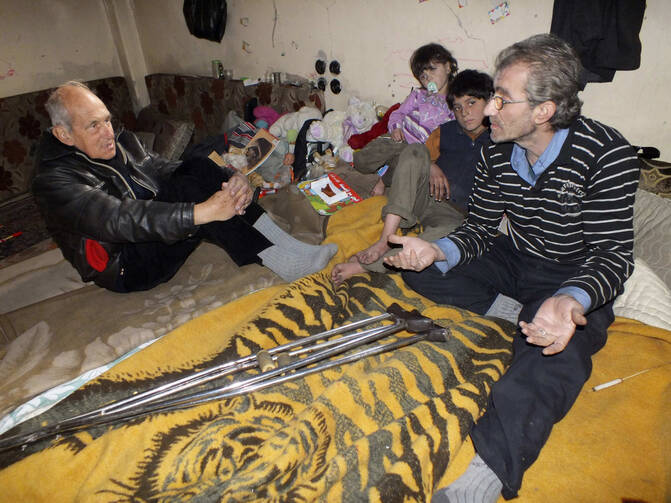 Dutch Jesuit Father Frans van der Lugt, visiting a family in the besieged area of Homs, Syria, on Jan. 30.