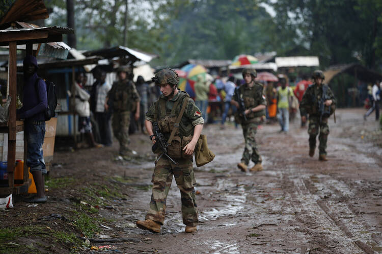 French soldiers patrol near St. Michael Catholic Church April 14 in the Central African Republic town of Boda. Thousands have died in ongoing violence between competing militias.