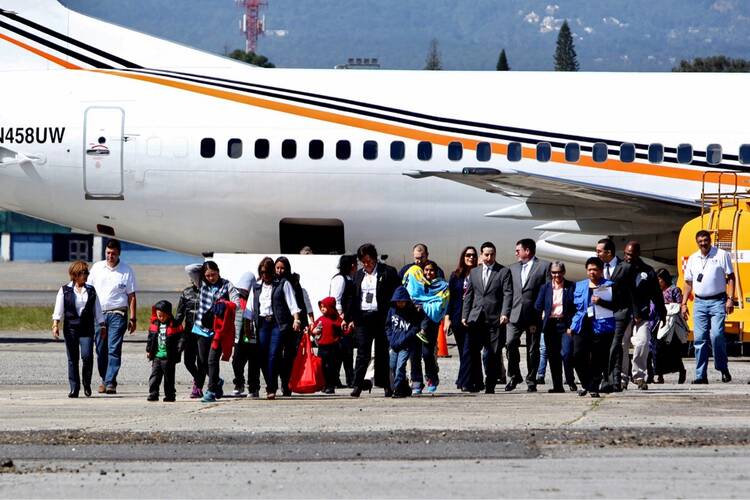 Four mothers and 10 children land in Guatemala City, Guatemala, Jan. 6 after being deported from the United States (CNS/photo/Esteban Biba, EPA).