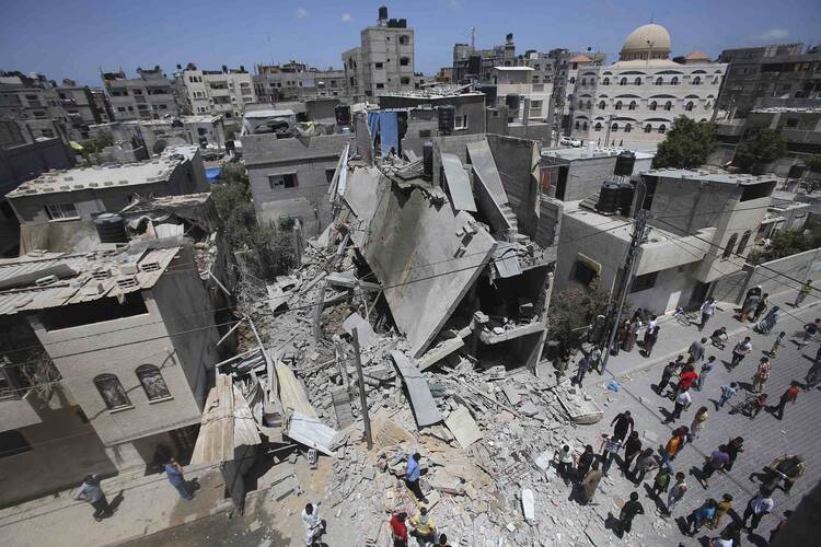 Palestinians in Rafah, Gaza Strip, gather around the remains of a house that police said was destroyed in an Israeli airstrike. 