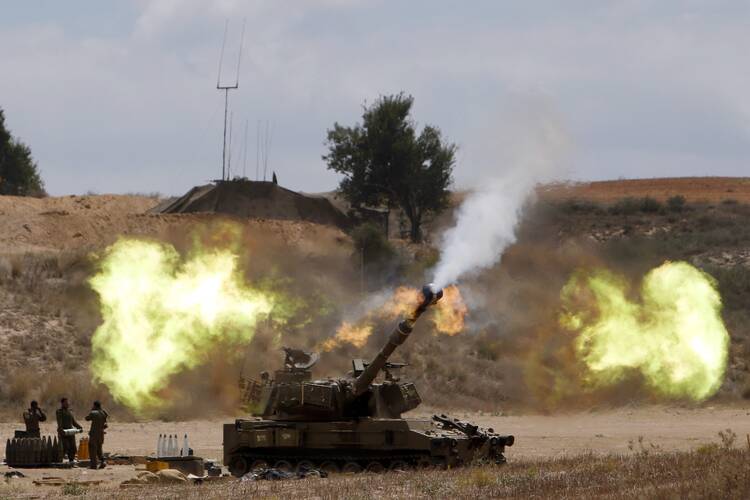 An Israeli mobile artillery unit fires toward the Gaza Strip July 18. Pope Francis telephoned Israeli President Shimon Peres and Palestinian President Mahmoud Abbas on July 18, urging all sides to end hostilities and build peace.