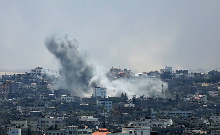 Smoke rises from Gaza City after an Israeli airstrike July 29. Violence escalated the previous night after an attempted unofficial truce for the three-day Eid al-Fitr holiday crumbled.