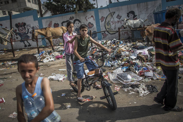 Palestinian children play outside a U.N. school that was transformed into a shelter in Jabalia, Gaza Strip, on July 29. 