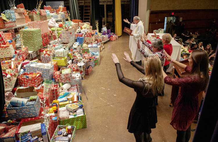 Priest leads blessing of Christmas gifts during the annual Mass at New York high school, 2013.
