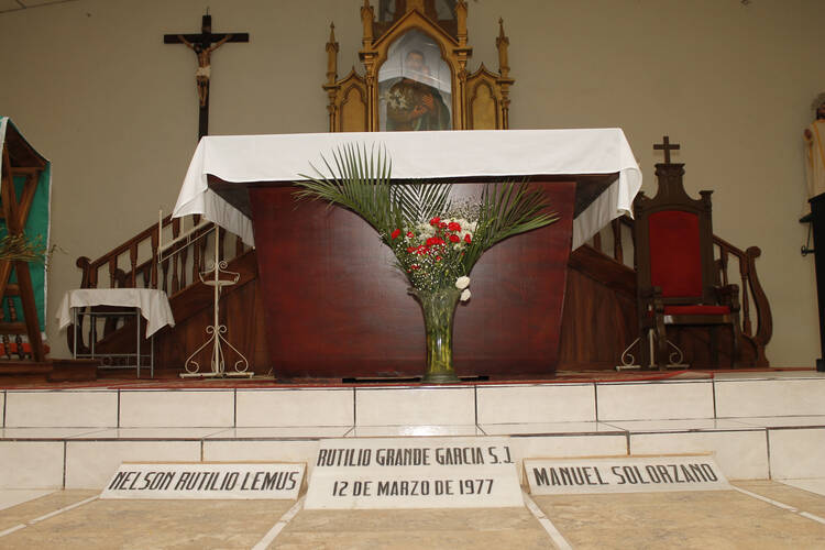 The tombs of Father Rutilio Grande, Manuel Solorzano and Nelson Lemus are seen inside a church in El Paisnal, El Salvador. (CNS photo/ Edgardo Ayala)