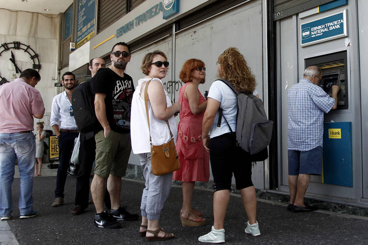 People queue to withdraw money from an ATM outside a branch of Greece's National Bank in Athens, Greece, July 6. (CNS photo/Alexandros Vlachos, EPA) 