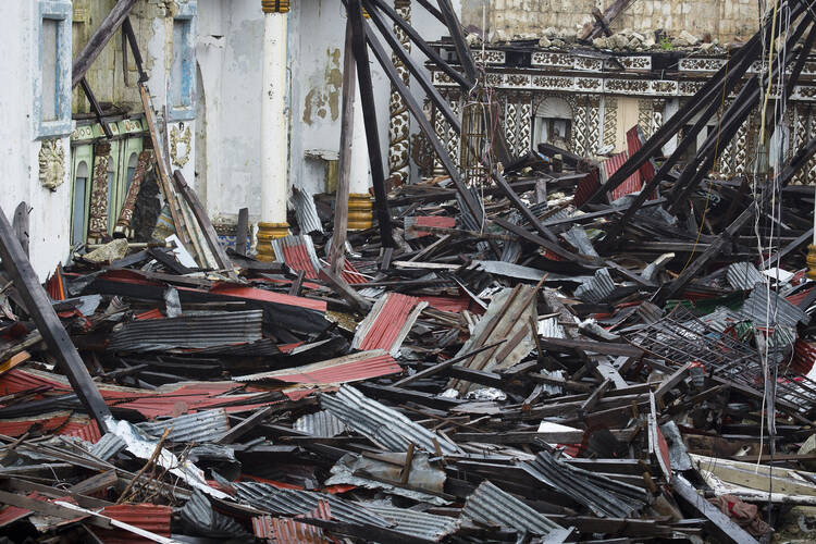 Metal roofing—remnants of November's Typhoon Haiyan—litters Immaculate Conception Church in Guiuan, Philippines, Feb. 9, 2014 (CNS photo/Tyler Orsburn).
