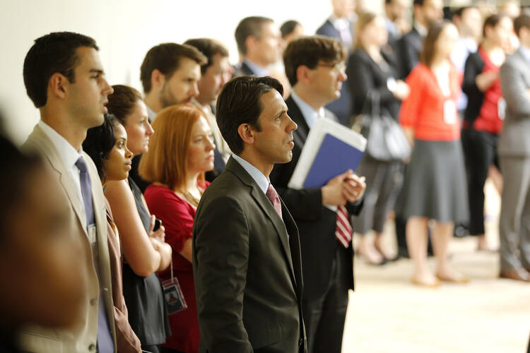 West Wing staff members listen as President Obama delivers remarks at White House about Supreme Court ruling on health care subsidies, June 25 ((CNS photo/Jonathan Ernst, Reuters). 