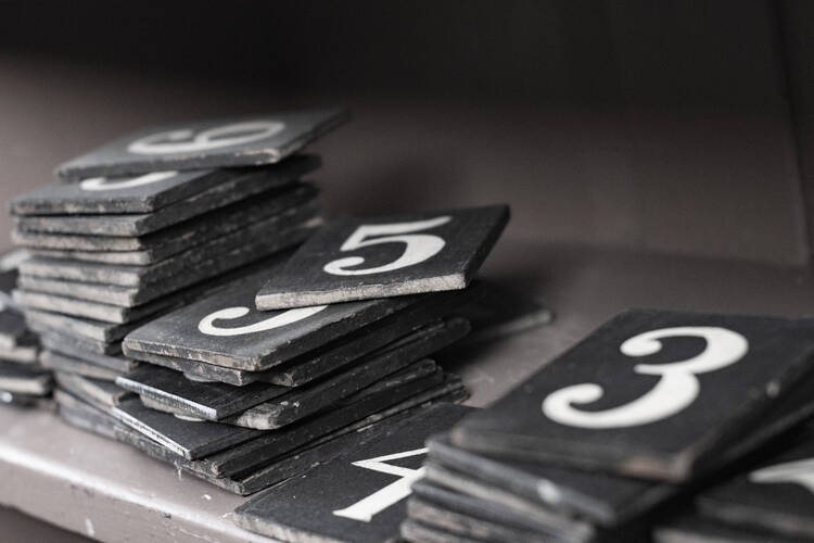 Number tiles await placement on the hymnal board. (iStock/linephoto)