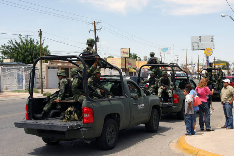 Mexican soldiers patrol the city of Ciudad Juárez during a visit by then-President Felipe Calderon on Aug. 9, 2011. (iStock/vichinterlang)