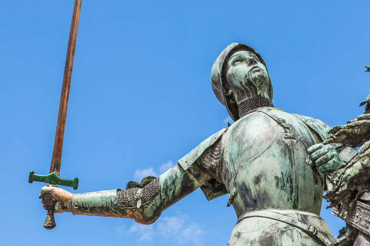 A bronze statue of Joan of Arc in the public space outside Reims Cathedral in France. (iStock/lucentius)
