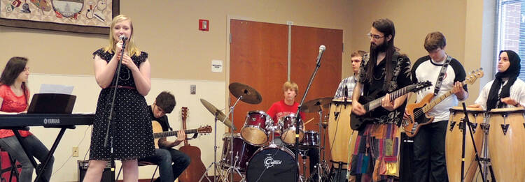 Austin Rose on drums with his band, Interfaith Rock