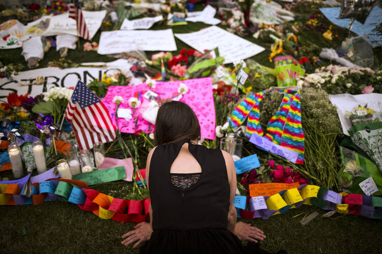 A woman visits a memorial in downtown Orlando, Fla., June 14, that honors the victims of the mass shooting at a gay nightclub. (CNS photo/John Taggart, EPA)