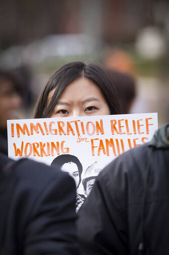 A woman holds a sign during an immigration rally in front of the White House, Nov. 19 (CNS photo/Tyler Orsburn).