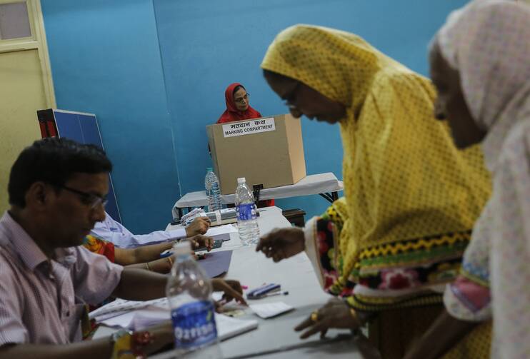 ONE OF MANY. Woman casts vote inside polling center during India's general election in Mumbai (CNS photo/Danish Siddiqui, Reuters).