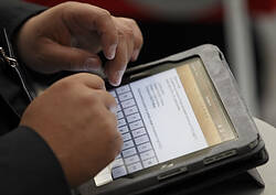 A participant uses an Apple iPad during the Catholic Press Congress at the Vatican Oct. 4. (CNS photo/Paul Haring) (Oct. 4, 2010) See PRESS-MISSION Oct. 4, 2010.