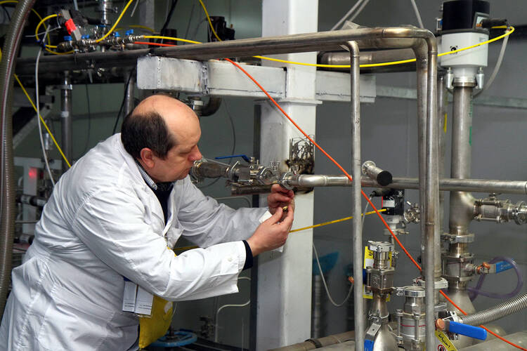 FURTHER EXAMINATION. An International Atomic Energy Agency inspector checks the uranium enrichment process inside Iran's Natanz plant in January (CNS photo/Kazem Ghane, EPA).