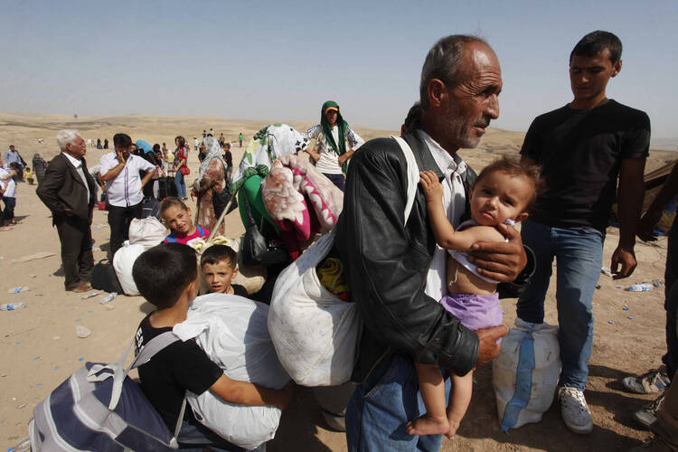 A BRUTAL CHESS GAME. Syrian refugees, fleeing the violence in their country, cross border into Kurdish region of northern Iraq, September 5, 2013.