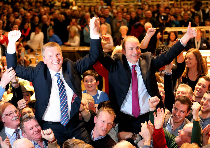  Fianna Fail Leader Micheal Martin, right, and Michael McGrath celebrate their party’s strong showing at City Hall in Cork, Ireland on Feb. 27 (Chris Radburn/PA via AP).