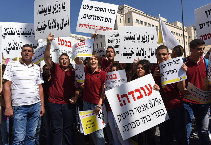 Israeli Arab Christians demonstrate outside Israeli Prime Minister Benjamin Netanyahu's office in Jerusalem Sept. 6, to protest government budget cuts to their schools. (CNS photo/Debbie Hill)
