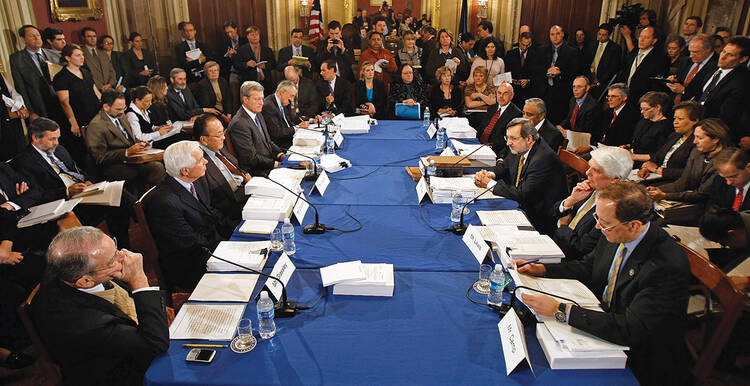 AT THE TABLE. Members of the Senate and House Appropriations Committees hash out differences between versions of legislation in the L.B.J. Room at the U.S. Capitol in February 2009.