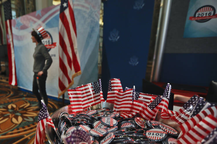 Pins reading "The America Decide" are displayed during a reception organized by the U.S. Embassy to wait for the results of the 2016 U.S. Presidential election, in Rome, Tuesday, Nov. 8, 2016. (AP Photo/Gregorio Borgia)