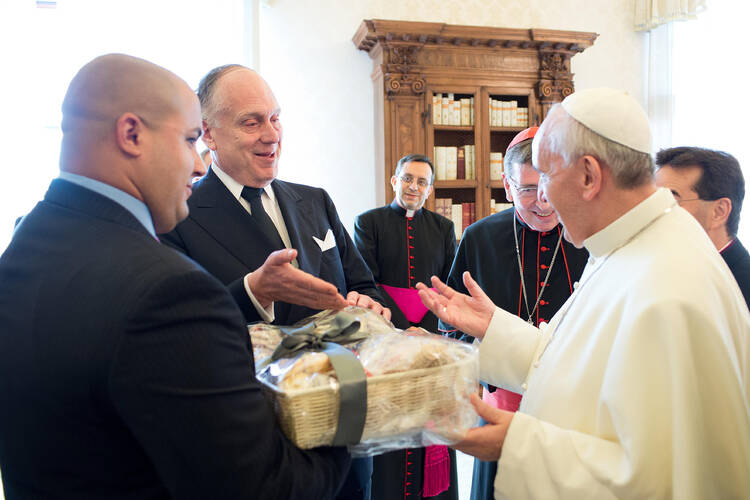 Pope Francis gestures as he receives a gift from a member of the World Jewish Congress during a private audience at the Vatican Sept. 2. (CNS photo/L'Osservatore Romano via Reuters)