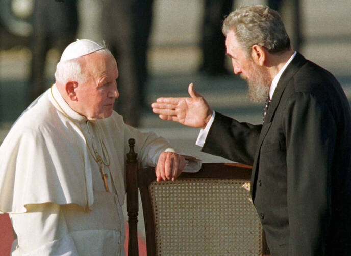 Cuban President Fidel Castro gestures to Pope John Paul II in Havana in 1998. It was the first visit to Cuba by a pope, and the Polish pontiff used it to appeal for greater religious rights. (CNS photo/Reuters) 