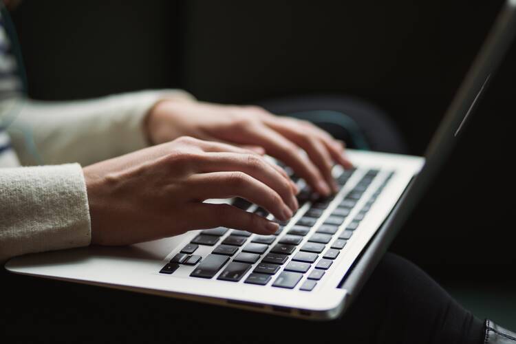 Person typing at a computer