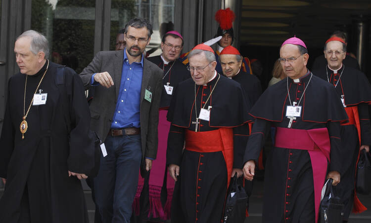 Cardinal Kasper and other prelates leave morning session of extraordinary Synod of Bishops on the family at the Vatican, Oct. 7.