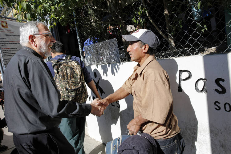 Bishop Gerald F. Kicanas of Tucson greets men entering the Kino Border Initiative soup kitchen Nogales, in northern Mexico, in 2014