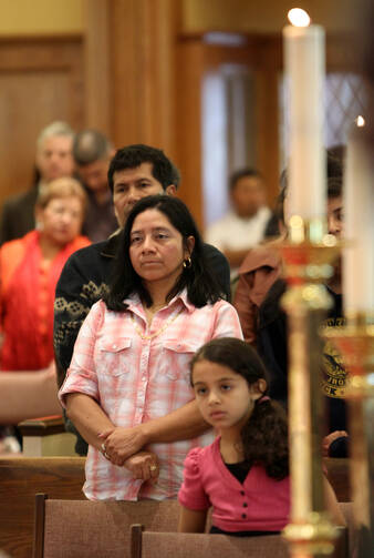 Latino worshippers stand during a special Mass honoring immigrants at St. John the Evangelist Church in Riverhead, N.Y., in 2011. (CNS photo/Gregory A. Shemitz, Long Island Catholic)