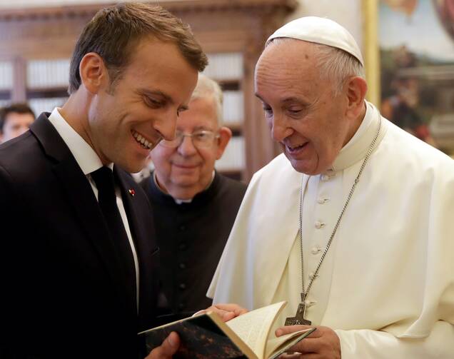 Pope Francis exchanges gifts with French President Emmanuel Macron during a private audience at the Vatican in June 2018. (CNS photo/ Alessandra Tarantino, pool via Reuters)