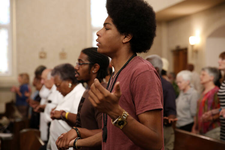 People gather for a special Mass marking the 50th anniversary of the March on Washington Aug. 25 at Holy Redeemer Catholic Church in Washington.