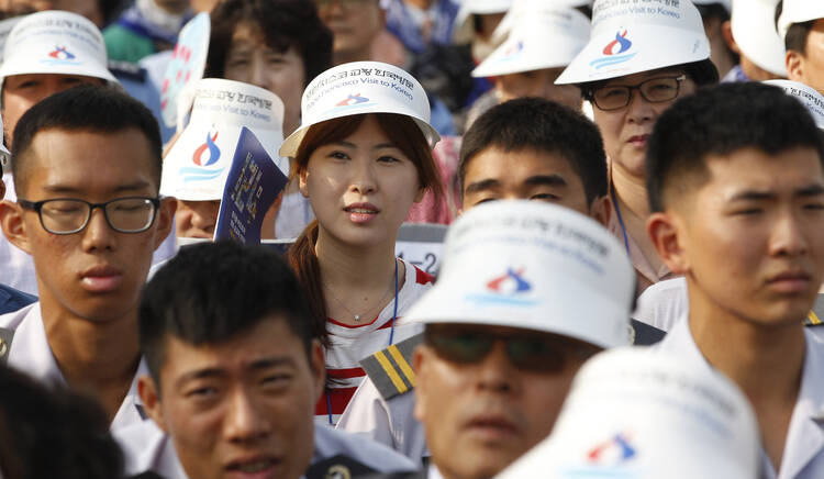 People wait for beatification Mass in Seoul, August 16.